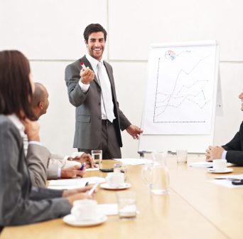 Man in suit leading discussion in conference room