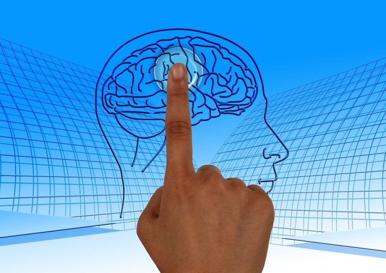 Finger pointing to drawing of a brain
