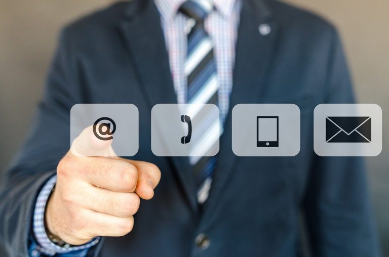 man in suit pointing to email icon
